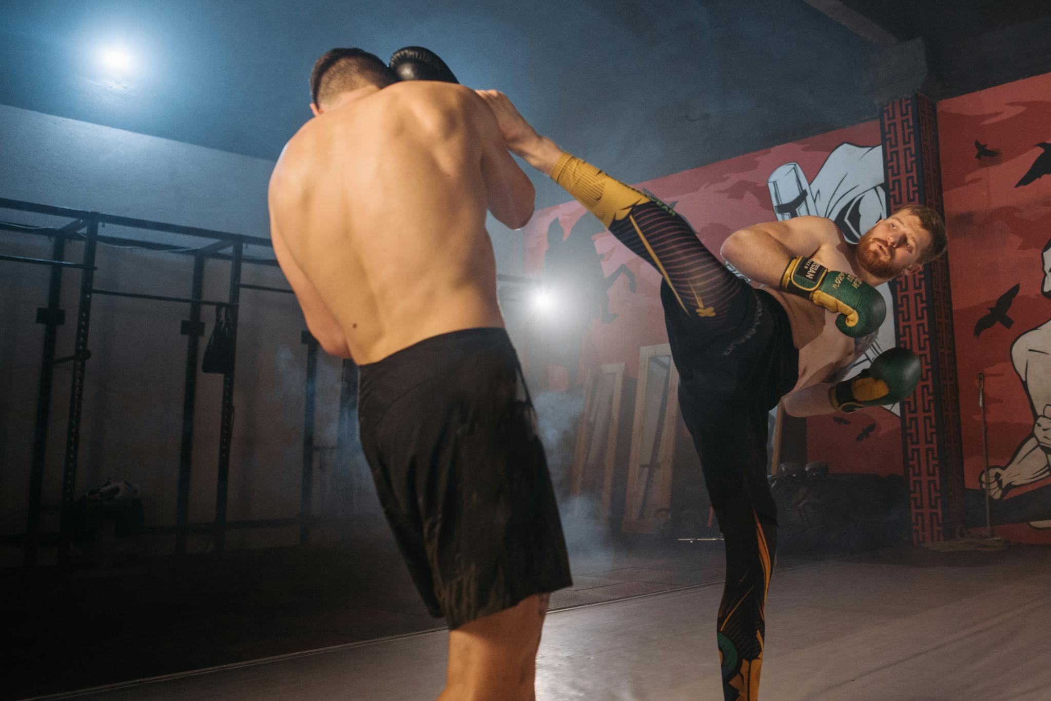 Two male athletes in intense martial arts training session, showcasing powerful moves.